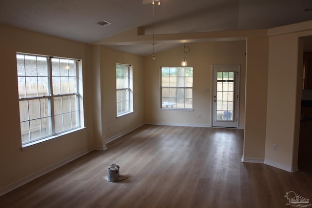 unfurnished dining area featuring visible vents, baseboards, lofted ceiling, and wood finished floors