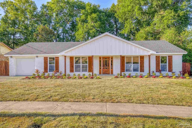 ranch-style home featuring covered porch, a garage, and a front lawn