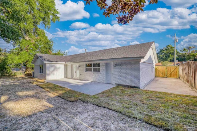 ranch-style home with a patio and a front yard