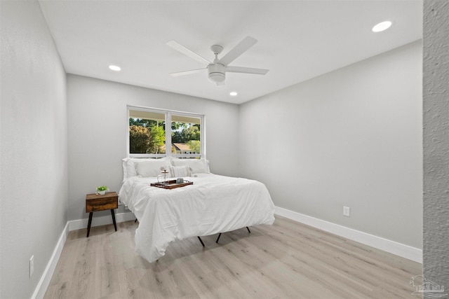 bedroom with light hardwood / wood-style floors and ceiling fan