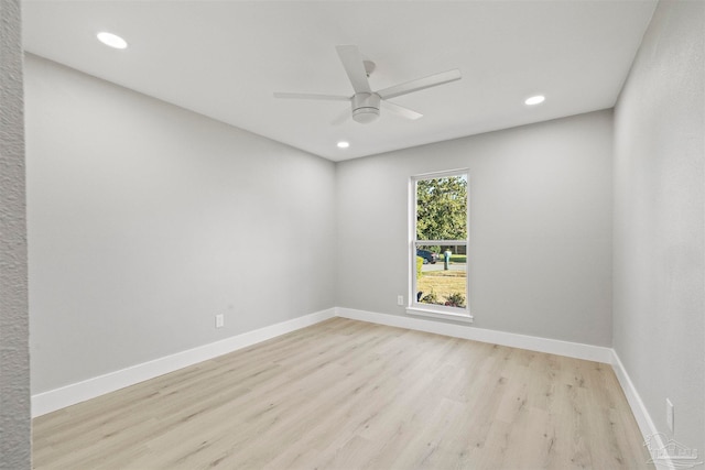 spare room with ceiling fan and light wood-type flooring