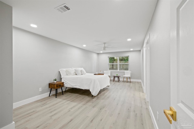 bedroom with light hardwood / wood-style floors and ceiling fan