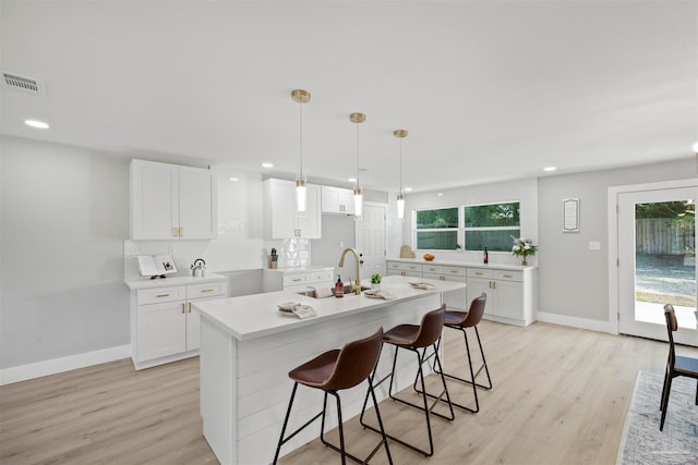 kitchen featuring white cabinetry and plenty of natural light