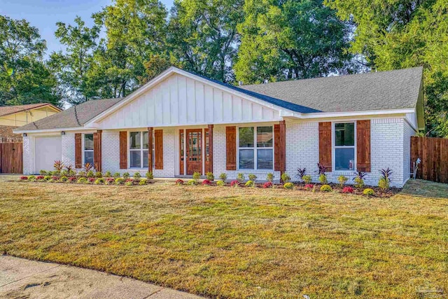 ranch-style home featuring a garage and a front lawn