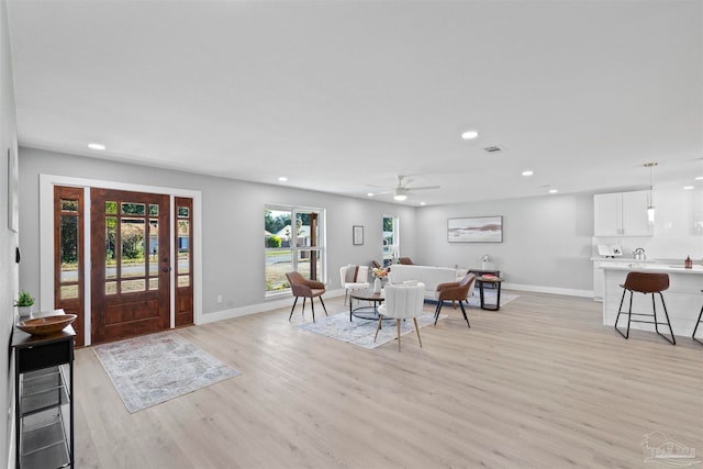 interior space with light wood-type flooring and ceiling fan