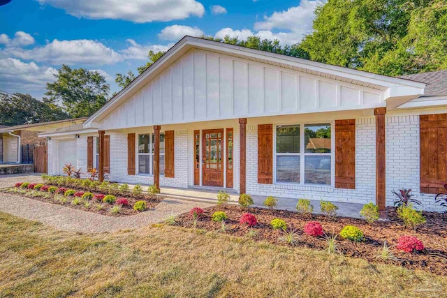 single story home with a front yard and a garage