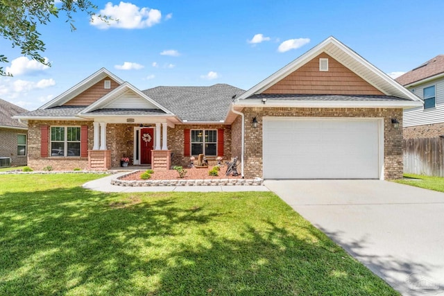 craftsman house with a garage, a front yard, and central AC unit