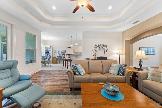 4951 Red Oak Dr, Milton, FL 32583 - living room with crown molding, wood finished floors, recessed lighting, a tray ceiling, and ceiling fan with notable chandelier
