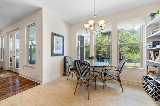 dining space with wood-type flooring and a chandelier