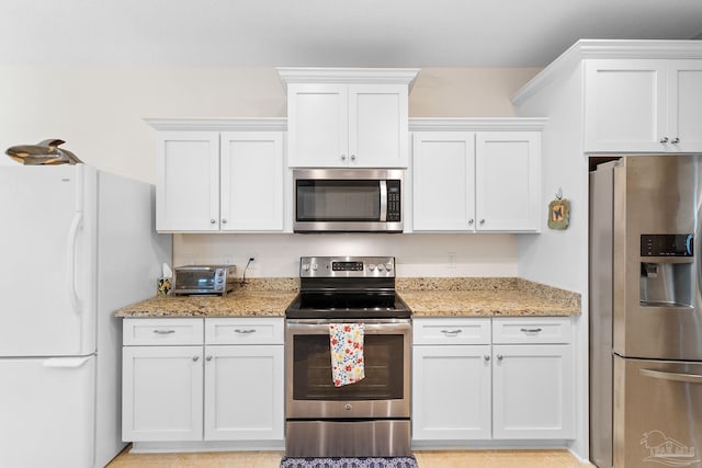 4951 Red Oak Dr, Milton, FL 32583 - kitchen featuring appliances with stainless steel finishes, light stone counters, and white cabinetry