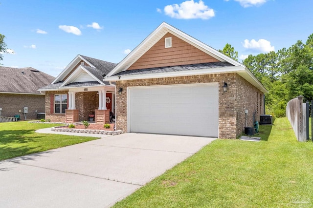 view of front of house with cooling unit, a front yard, and a garage