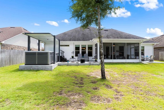 back of house featuring a patio area, a sunroom, a lawn, and a jacuzzi