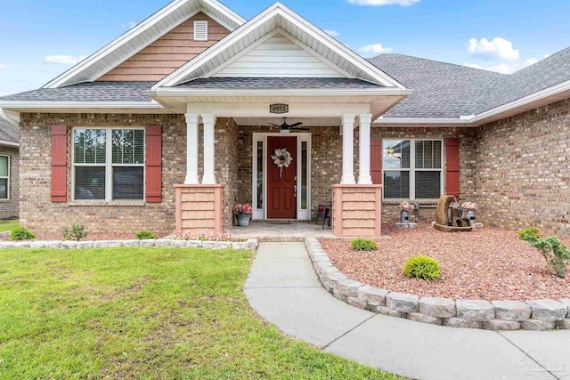4951 Red Oak Dr, Milton, FL 32583 - view of front of home featuring covered porch, brick siding, a shingled roof, and a front lawn