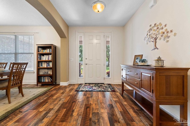 4951 Red Oak Dr, Milton, FL 32583 - foyer with baseboards, arched walkways, and wood finished floors