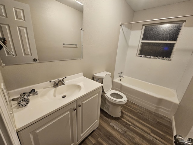 full bathroom featuring vanity, toilet, hardwood / wood-style floors, and shower / bathing tub combination