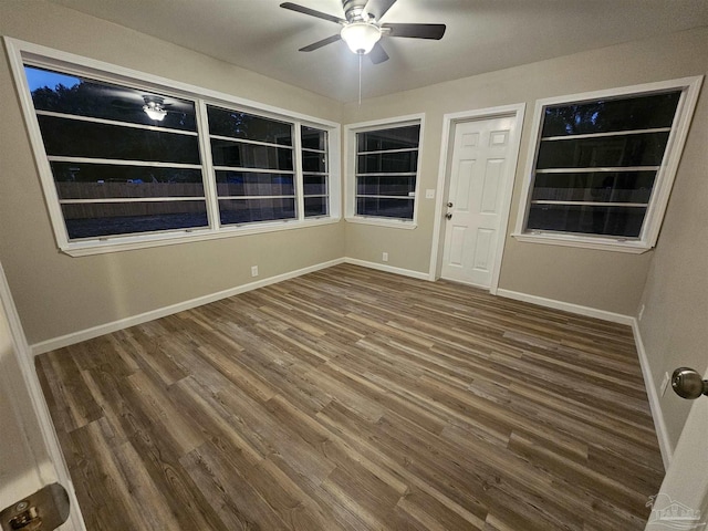 unfurnished room with ceiling fan and dark hardwood / wood-style flooring