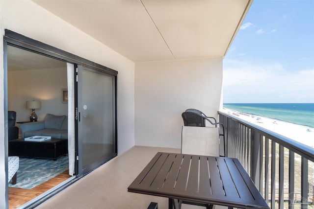 balcony featuring a water view and a view of the beach