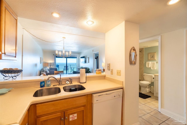 kitchen with sink, light tile patterned floors, white dishwasher, a notable chandelier, and a textured ceiling