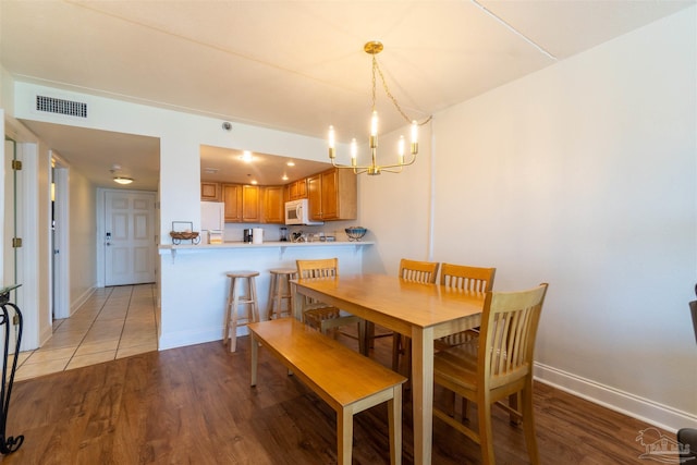 dining room featuring a chandelier and light hardwood / wood-style flooring