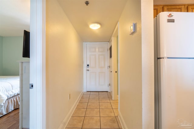 hall featuring light tile patterned flooring