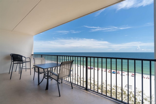 balcony featuring a water view and a beach view