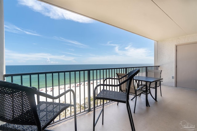 balcony featuring a water view and a beach view