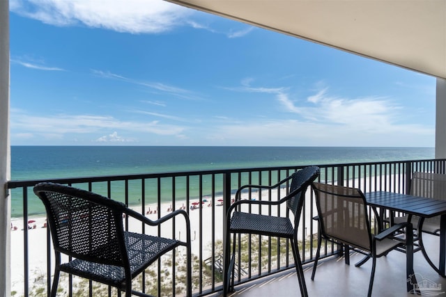 balcony featuring a water view and a beach view