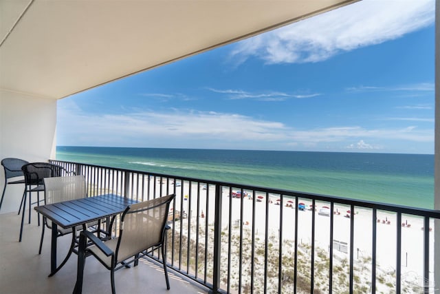 balcony with a water view and a beach view