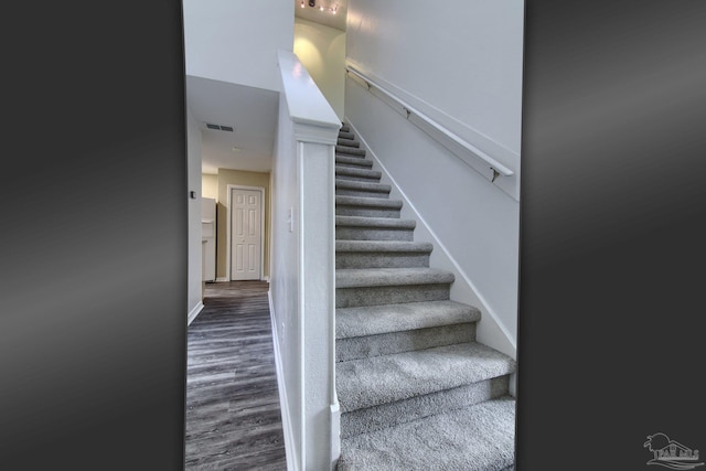 staircase featuring wood-type flooring