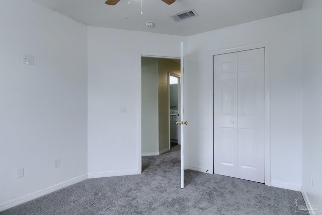 unfurnished bedroom featuring carpet floors, a closet, and ceiling fan