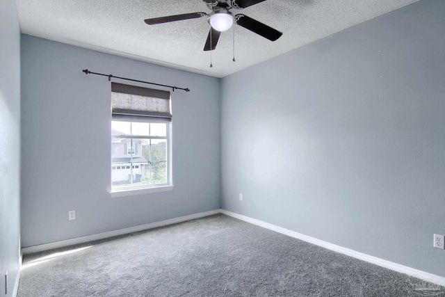 carpeted spare room featuring a textured ceiling and ceiling fan