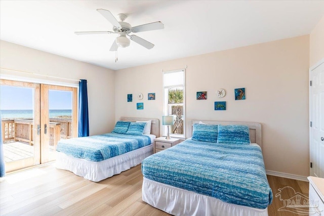 bedroom featuring access to exterior, wood finished floors, baseboards, and ceiling fan