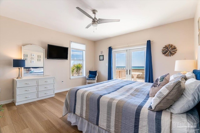 bedroom with french doors, light wood finished floors, baseboards, and access to outside