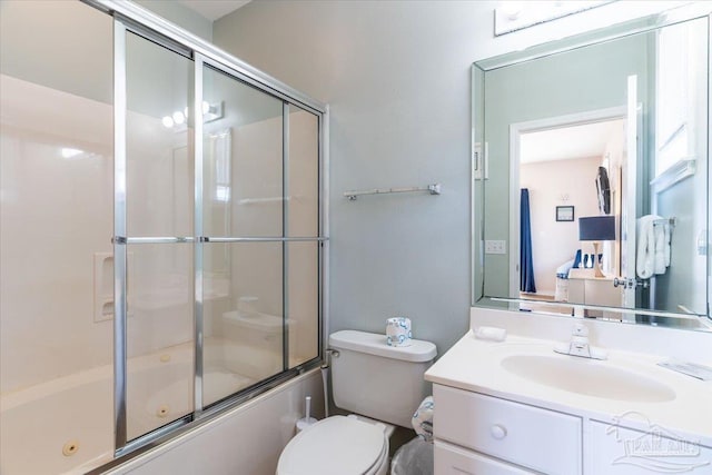 bathroom featuring toilet, vanity, and a combined bath / shower with jetted tub