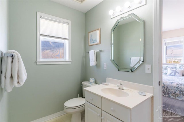 bathroom featuring visible vents, toilet, ensuite bath, baseboards, and vanity