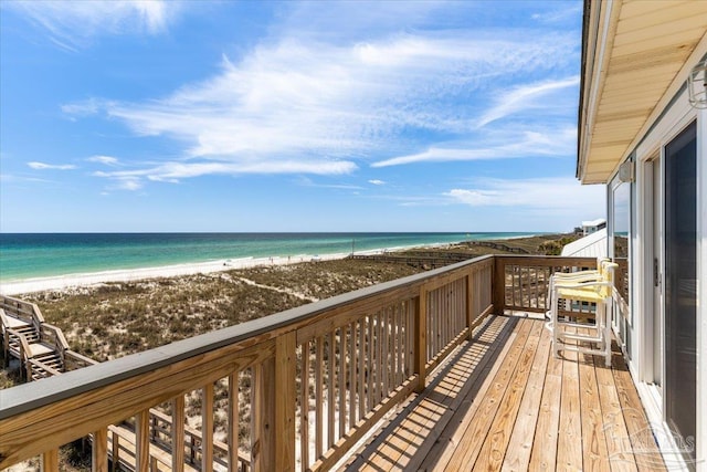 balcony featuring a view of the beach and a water view