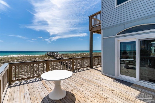 wooden terrace with a beach view and a water view