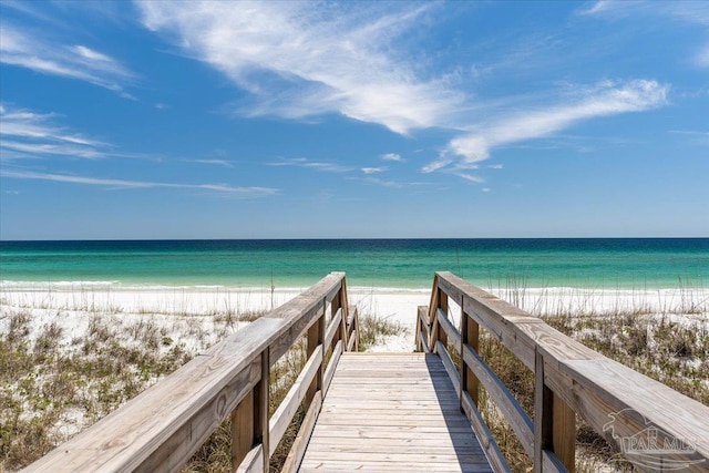 view of home's community featuring a water view and a beach view