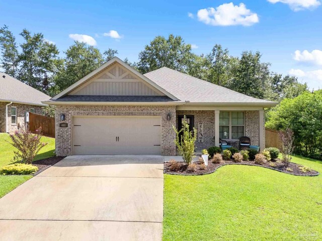 view of front of house featuring a garage and a front lawn