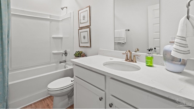 full bath with toilet, wood finished floors, vanity, and shower / bathtub combination with curtain