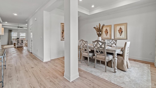 dining space with ornamental molding, light wood-style flooring, recessed lighting, and decorative columns