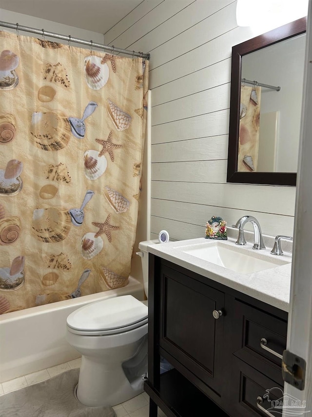 full bath with vanity, tile patterned floors, shower / bath combination with curtain, toilet, and wood walls