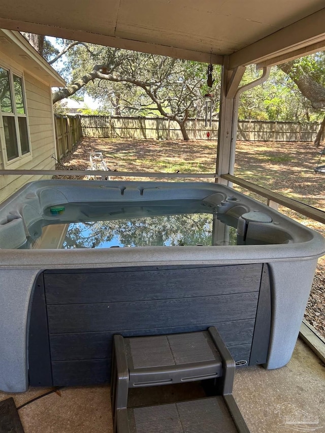 view of patio / terrace featuring a fenced backyard and a hot tub