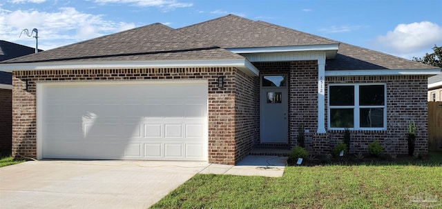 ranch-style house featuring a front yard and a garage