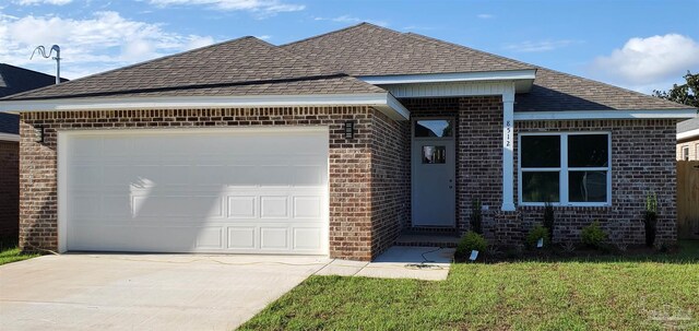 8512 Esplanade St, Navarre, FL 32566 - view of front of property featuring brick siding, a shingled roof, concrete driveway, and an attached garage