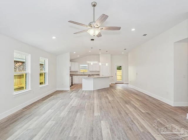 8512 Esplanade St, Navarre, FL 32566 - unfurnished living room with lofted ceiling, light wood-type flooring, ceiling fan, baseboards, and recessed lighting