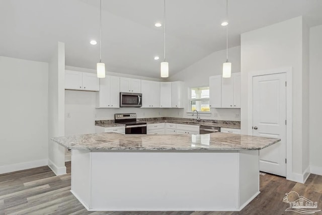 8512 Esplanade St, Navarre, FL 32566 - kitchen featuring stainless steel appliances, vaulted ceiling, a sink, baseboards, and white cabinets