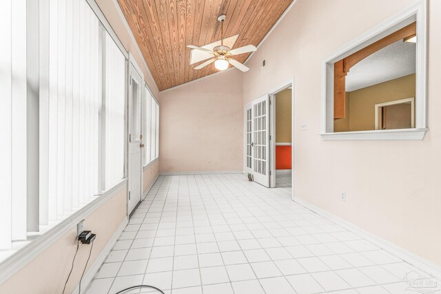 unfurnished sunroom with vaulted ceiling, wood ceiling, and ceiling fan