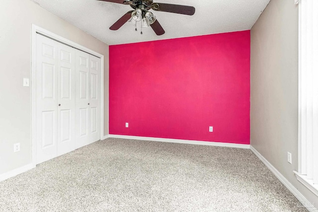 unfurnished bedroom featuring a textured ceiling, carpet, and ceiling fan