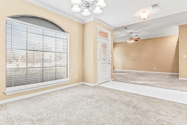 empty room with ceiling fan with notable chandelier, light carpet, crown molding, and a textured ceiling